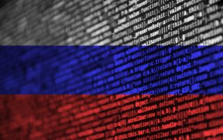 Russia flag is depicted on the screen with the program code. The concept of modern technology and site development