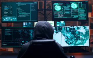Back view of male hacker wearing a hoodie